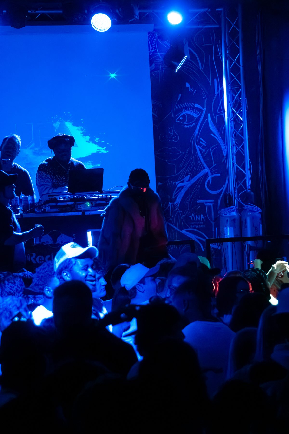 DJ working the decks under blue light