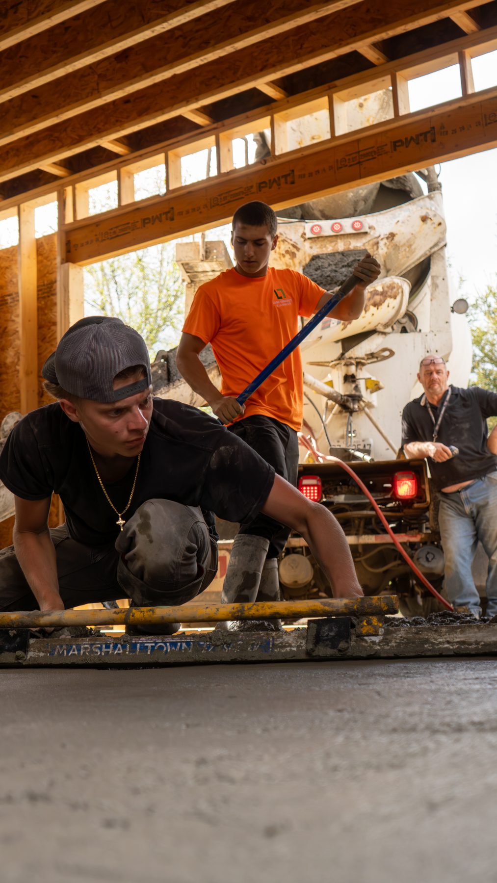 Crew working beneath heavy timber framing